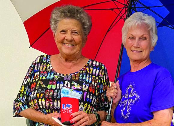 For the most bunco game losses, Fraya Hammons receives a koozie containing mosquito bracelets. Beverly Ray wins the Texas flag umbrella for throwing the most buncos as the dice game became quite exciting. The approximately 30 seniors in attendance dined on homemade Butterfinger, strawberry and vanilla ice cream for dessert.