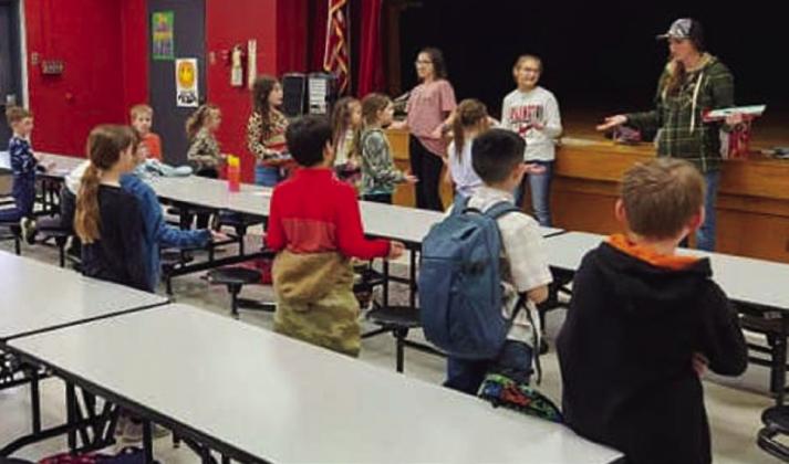 Collingsworth County 4-H Club Officers Brylnn Kemp and Ava Kate Inman open the Tuesday, Feb. 7 meeting, assisted by Club Manager Molly Sims. Courtesy Photos