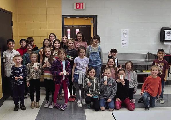 Clover Kids and Sparkler 4-H Club members display Valentine’s Day cards, designed for home health patients.