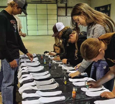 Hall County 4-H members create non-slip socks for Memphis Convalescent Center residents at the recent December club meeting, which was held Sunday, Dec. 11 at the Hall County Show Barn. Photo Courtesy of Hall County 4-H