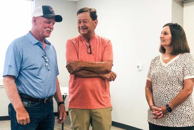 Arnie Ingram visits with guests Carl and Jeanne Taylor, his brother-in-law and sister-inlaw, during the recent reception in his honor hosted by the City of Wellington on Friday, June 20, marking his career of over 45 years.