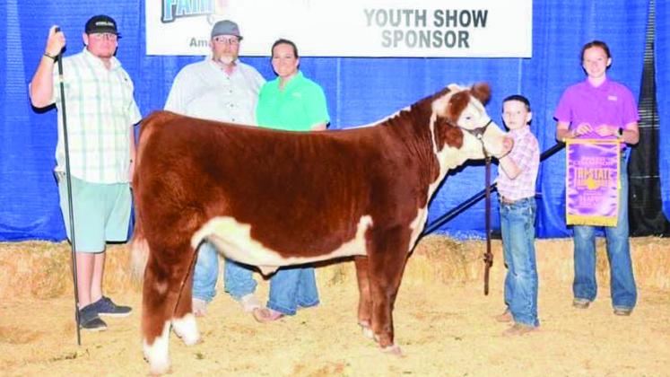 Jacob Page, a third grader at Wellington Elementary School, exhibits the Hereford Breed Champion with his steer, Hank, at the recent Tri-State Fair and Rodeo in Amarillo. From left: Trevor Rosso, Jeremy Page, Katie Page, Jacob Page, Bailey Page. Courtesy Photos