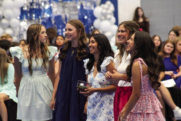 The varsity Childress Lady Cat golf team, including Joshlynn Roark, Colee Cox, Isabella Jurado, Emma Jalomo and Olivia Jurado, showcase a Lady Cat-signed golf ball for auction.
