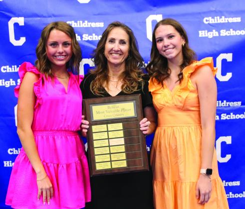 Adlee Lambert, left, and Natalie Pierce, right, are awarded Lady Cat Cross Country Co- Most Valuable Player, presented by head cross country coach Mary Trimmer.