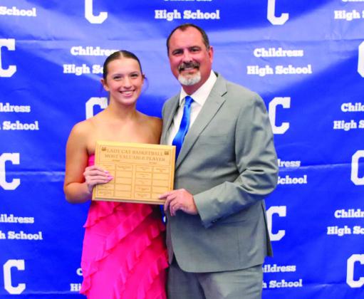 Joshlynn Roark, left, is awarded Lady Cat Basketball Offensive Most Valuable Player, presented by head girls’ basketball coach Eric Davis.