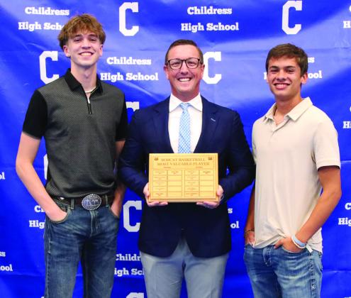 Raine Walsh, left, and Caleb Moore, right, are awarded Bobcat Basketball Offensive Co- Most Valuable Player, presented by head boys’ basketball coach Colby Schniederjan.