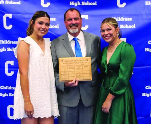 Journey Prince, right, and Emma Jalomo, left, are awarded Lady Cat Basketball Defensive Most Valuable Player, presented by head girls’ basketball coach Eric Davis.