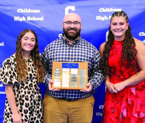 Addi Baize, left, is awarded Lady Cat Track Most Valuable Player, and Taylor Wiseman, right, is awarded Lady Cat Field Most Valuable Player, presented by head track and field coach Kolby Pool.