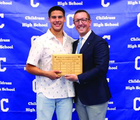 Jacob Mora, left, is awarded Bobcat Basketball Defensive Most Valuable Player, presented by head boys’ basketball coach Colby Schniederjan.