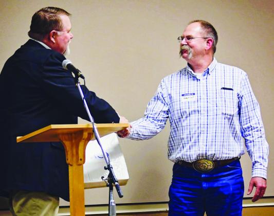 Collingsworth County District Conservationist Robert Self, right, receives congratulations from United Sates Department of Agriculture-Natural Resource Conservation Service Assistant State Conservationist Chad Reed at the Texas Soil and Water Board’s annual awards banquet. Courtesy Photo