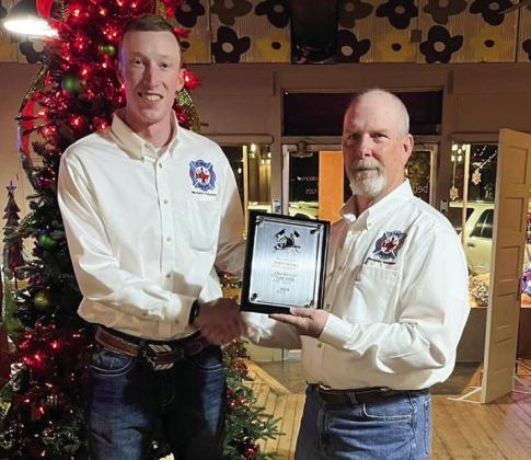 Photos Courtesy of Memphis VFD Memphis Volunteer Firefighter Zack Fisher receives Fireman of the Year, presented by Memphis Volunteer Firefighter Terry Altman, Saturday, Dec. 14 during the department’s Christmas party at Bertie Fannie.