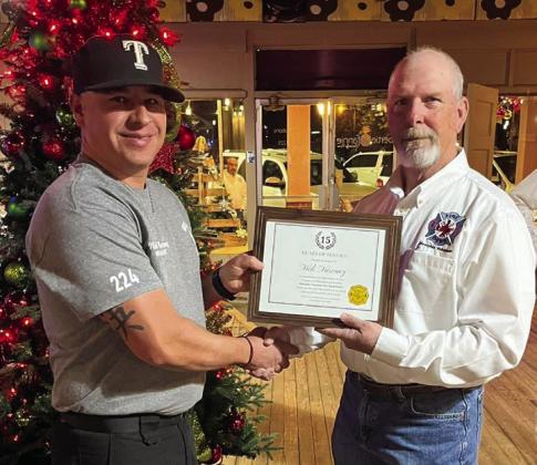 Memphis Volunteer Firefighter Nick Narvaez receives a 15-year service award, presented by Memphis Volunteer Firefighter Terry Altman.