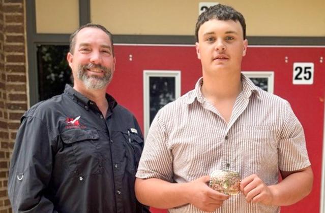 Wellington High School (WHS) Future Farmers of America (FFA) Advisor Drew Taylor congratulates sophomore Aison Skelton on his first-place accolade in the recent SMAW 1F Wichita Falls Welding Contest. WELLINGTON HIGH SCHOOL