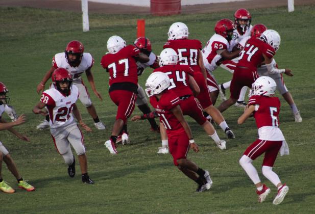 Wellington junior varsity Skyrocket Major Brown (6) attempts a pass with blocking by Kingston Molina (51), Yobani Moreno (77), Hunter Hedrick (54), Dixon Dugan (50) and KJ Molina (64) in the match against Borger Thursday, Oct. 5 at Powell Field. The Rockets moved to 6-0 overall, thanks to a big 40-0 win over the Bulldogs. The Red River Sun/Shauna Salinas