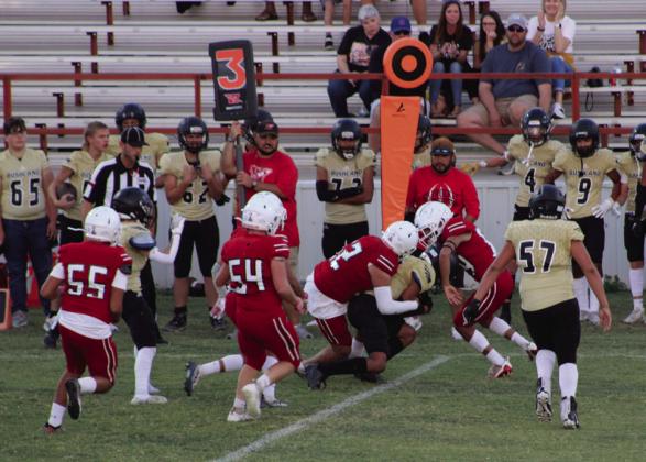 Junior varsity Skyrockets Gustavo Soto (22) and KJ Molina (64) wrap up a Bushland Falcon as Hunter Hedrick (54) and Armando Hinojosa (55) come in to assist last Thursday, Oct. 12. The team remains undefeated on the season, winning 12-0. The Red River Sun/Shauna Salinas