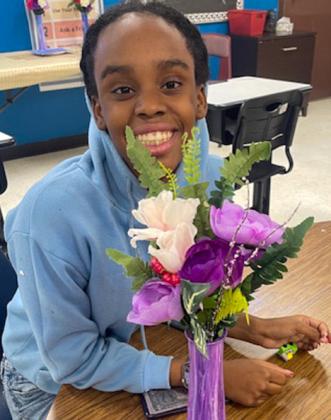 Junior high art students create acrylic pour canvases, vases