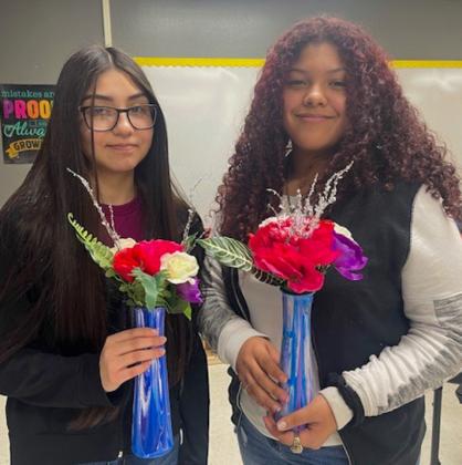 Junior high art students create acrylic pour canvases, vases