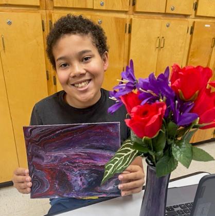Junior high art students create acrylic pour canvases, vases