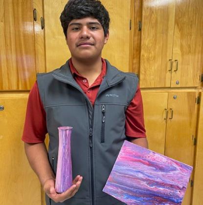 Junior high art students create acrylic pour canvases, vases