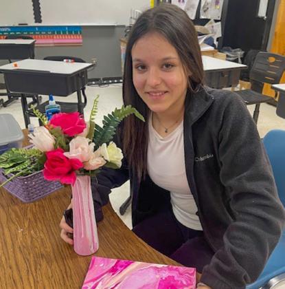 Memphis Junior High School art students create acrylic pour canvases and vases, which they completed with flowers, to make special Valentine’s Day gifts. Photos Courtesy of Memphis ISD