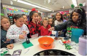 Austin Elementary School second graders create faux snow, using baking soda and shaving cream, with the help of teacher Shaneque Shipp. Photos Courtesy of Memphis ISD