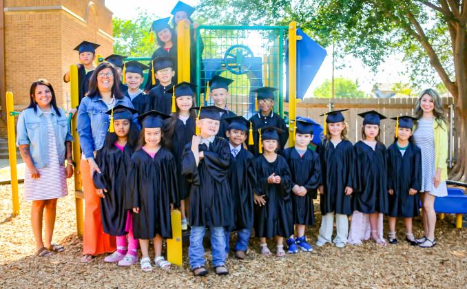 Suited in caps and gowns, the Austin Elementary School Class of 2029 waves goodbye to kindergarten. KKR PHOTOGRAPHY