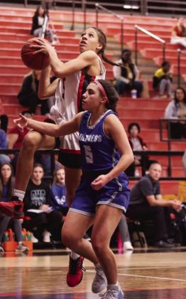 Childress’ Aspen Lomax (5) attempts to block a layup by Tascosa’s Devaeh Johnson (15).