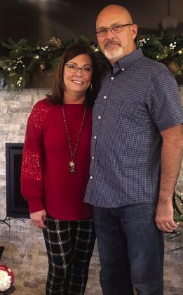 Linda and Lonnie Duke pause at the cozy fireplace of their beautifully renovated 15th St. home in Wellington as crowds cleared out following the Sunday, Dec. 3 Hearts United Give Support (HUGS) Holiday Home Tour. Courtesy Photos