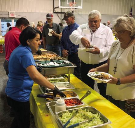 The Plaza Restaurant staff, of Altus, Okla., serves Ronnie and Trish Ward, of Wellington, and others during Tri-County Co-Op’s Annual Meeting on Thursday, Sept. 15 at the Dodson Family Life Center.