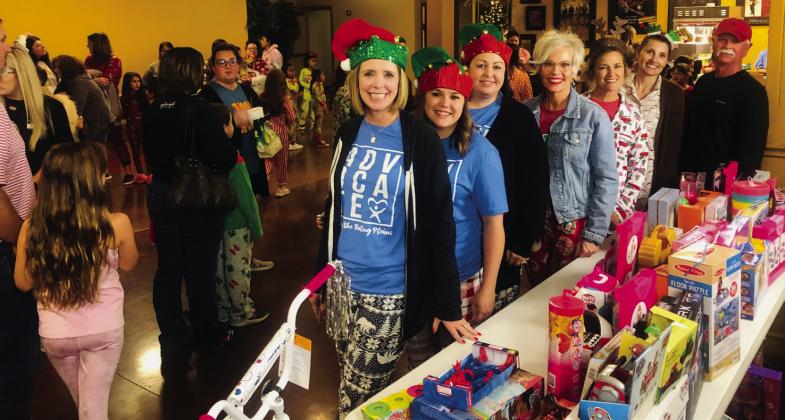 Court Appointed Special Advocates (CASA) of the Rolling Plains Executive Director Connie Monzingo, left, Volunteer Coordinator Nicole Brooks and Program Director Jamie Hall gather with Ritz Theatre Board President Lyndy Forrester-Black and Ritz Board Members Amy Inman, Tracey Ouellette and Eddie Langford for a Merry and Bright PJ Dance Party Thursday, Dec. 8. With admission being a $5 toy per family, gifts benefit children served by CASA of the Rollings Plains. The Red River Sun/Bev Odom