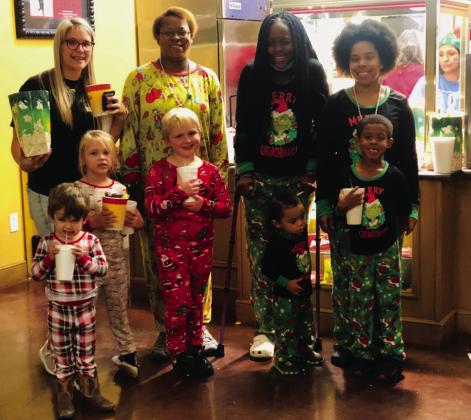 Friends and family, arms full of refreshments, head into the auditorium to see “Trolls Holiday.” Front, from left: Hudson Warren, Hallie Warren, Landry Mixon, Augustus Ramirez, Xander Pereira. Back, from left: Brittany Warren, Angie McDanel, Jayla Kilgore, Courtney Culpepper.