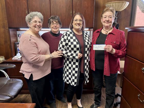Modern Home Club representatives present a check to Childress Helping Hands’ Kacy Crouch. Courtesy Photo