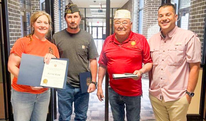 Wellington High School (WHS) art instructor Marnie Kane displays the Smart/Maher Veterans of Foreign Wars (VFW) National Citizenship Education Teacher Award, given by Glynn Moore VFW Post 6439 Senior Vice Commander Johnny Davis and Quartermaster Jr. Castillo. WHS Principal Jermaine Cantu offers his congratulations. From left: Kane, Davis, Castillo, Cantu.