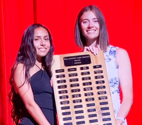 Wellington High School senior Sabrina Segovia accepts the Girls’ Track Distance Runner Award, presented by Coach Courtney Head.