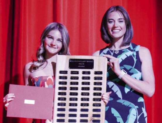 Wellington High School freshman Kambrie Fisher accepts the Girls’ Track Sprinter Award, presented by Coach Courtney Head.