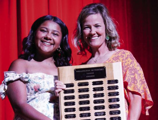 Wellington High School junior Jasmin Moreno accepts the Tennis Most Improved Girl, presented by Coach Amy Inman.