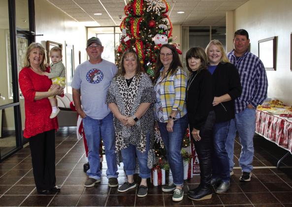Childress Municipal Development District, along with Global Well Control, George Butler Associates (GBA) and Pease River Ventures, hosts a Holiday Open House at their newly opened location, 501 Commerce St. NW, Thursday, Dec. 8. From left: Carla Springer with granddaughter Corabelle Brown, Gary Clark, Kelly Taylor, Donna Anders, Linda Shaw, Sheabree Nix, Craig McClendon. Not pictured is Dane Fuller. The Red River Sun/Elizabeth Tanner