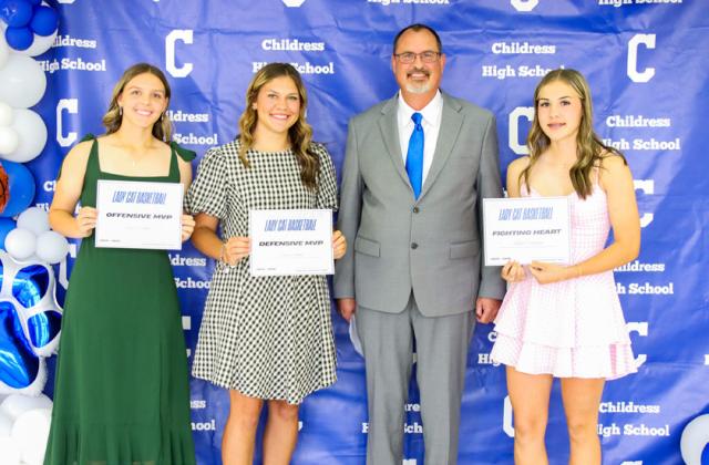 Landry Hunter receives the Lady Cat Basketball Offensive Most Valuable Player (MVP) Award, Emma Jalomo receives the Lady Cat Basketball Defensive MVP Award and Kinley Galligan receives the Fighting Heart Award, presented by Lady Cat Head Basketball Coach Eric Davis. From left: Hunter, Jalomo, Davis, Galligan.