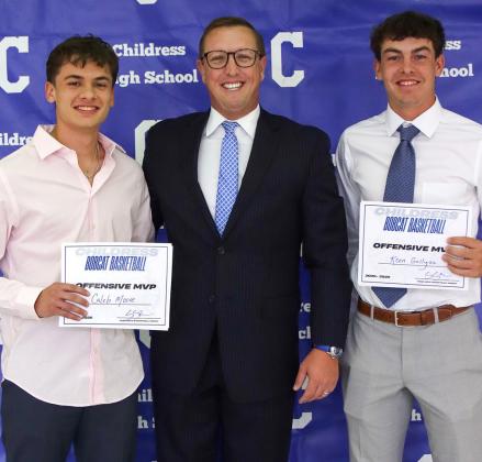 Caleb Moore and Koen Galligan receive the Bobcat Basketball Offensive Most Valuable Player Award, presented by Bobcat Head Basketball Coach Colby Schneiderjan.