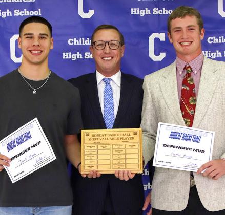 Jacob Mora and Cutter Bruce receive the Bobcat Basketball Defensive Most Valuable Player Award, presented by Bobcat Head Basketball Coach Colby Schneiderjan.