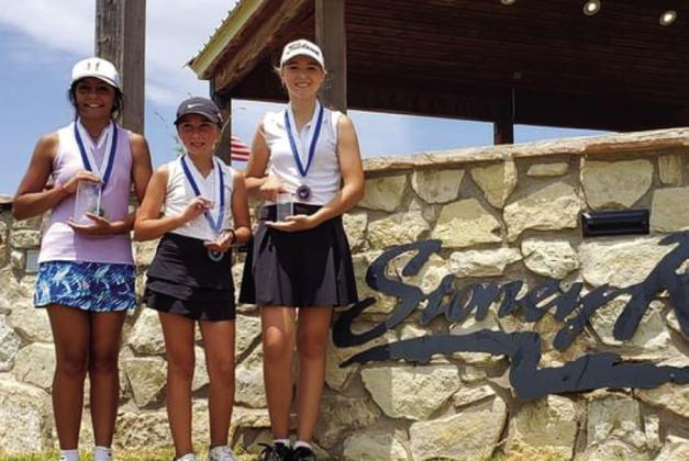 Junior-high girls accept end-of-year awards. From left: Camila Quinonez, first, Quanah; Clara Stafford, second, Altus, Okla.; and Claire Taylor, third, Altus, Okla.
