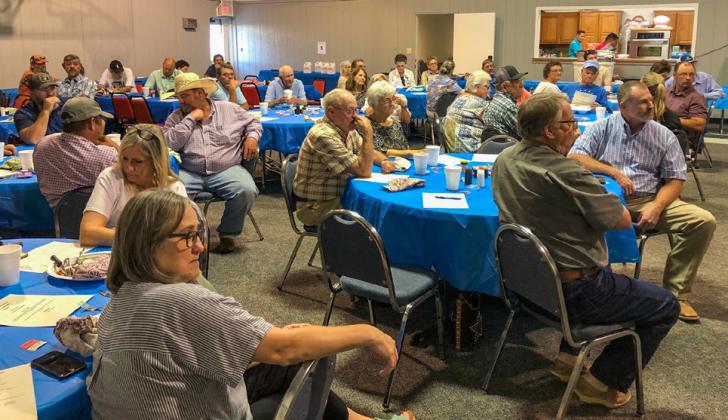 During Tri-County Co-Op’s Aug. 24 dinner event, participants listen as Manager Jeff Camp gives his annual report. Courtesy Photo