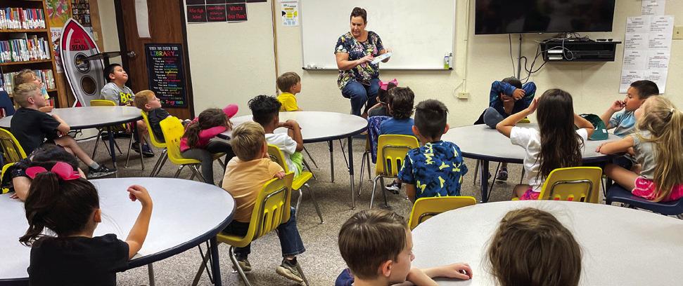 Representing the Collingsworth County Retired School Personnel Association (CCRSP), Penny Davis shares a book with Leslie Wiebe’s kindergarten students during the recent event. Retirees also read to Rhae Jones’ Head Start students and Kacy Cabbell’s kindergarten students. Barbara Roberson, also a member of CCRSP, made the arrangements and gathered the books for presentation to the young readers.