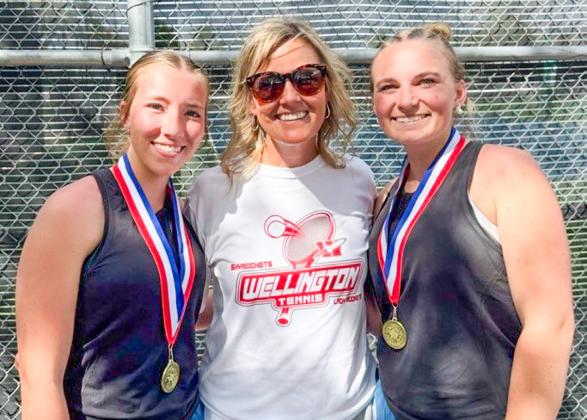Senior Lady Rocket cousins Brynlee Proffitt, left, and Oakley Folk, right, gather with Coach Amy Inman to celebrate the recent girls’ doubles district championship. Wellington High School