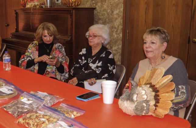 Dessert table volunteers, including Paulette Martin, left, Bana Morris and Marilyn Benham, offer baked goods, including cookies, cakes and bagged snacks.