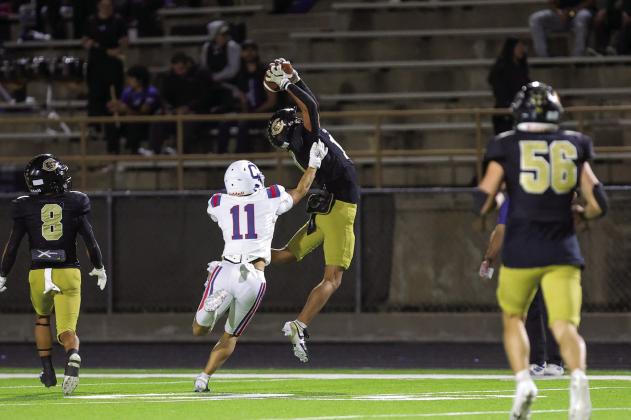 Childress’ Elliot Theparrukkul attempts to stop an interception by Canadian defensive back C.J. Jimenez during a district championship matchup Friday, Nov. 7 at Wildcat Stadium in Canadian. Press Pass Sports/Carter Pirtle
