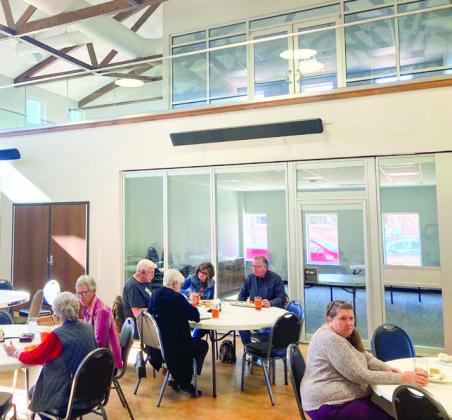 Looking to the west inside the Senior Community Café, Sallie O’Hair, Pat Barnett, Dennis and Jo Anne Kershner, Neal and Bev Odom and Phyllis Floyd gather for lunch, served from 11:30 a.m. to 12:30 p.m. Monday, Nov. 21. The facility features two activity rooms downstairs and an office area upstairs. Photo Courtesy of Ray Floyd