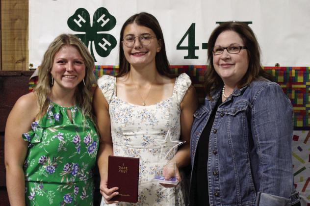 Taylor Wiseman, center, receives the Childress County 4-H Gold Star from 4-Her Savannah Rabe and Childress County Judge Kimberly Jones.