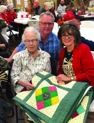 Neal and Bev Odom, with Odessa Covey, show appreciation for the queen-size, “nine-patch” quilt constructed and hand quilted by Covey in 2005. A special feature during the 2022 Methodist Women’s Fall Bazaar, the auction of the two keepsake quilts took place at 12:30 p.m. Saturday, Nov. 5. Courtesy Photo