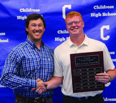 Ethan Ferguson, right, accepts the Coach Walter Depew Lineman Award from Offensive Coordinator Reid Ware.